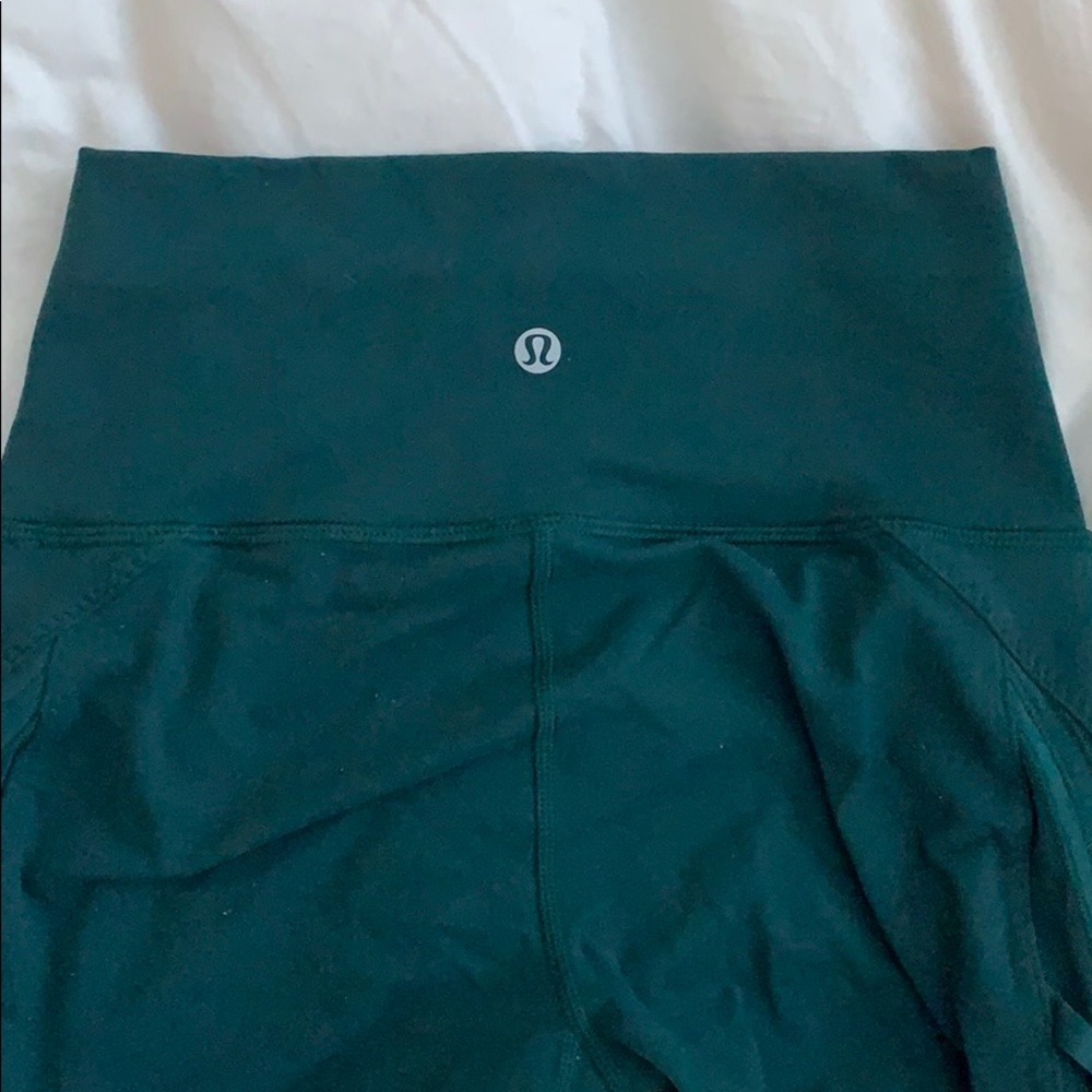 Lululemon peekaboo tights in teal.